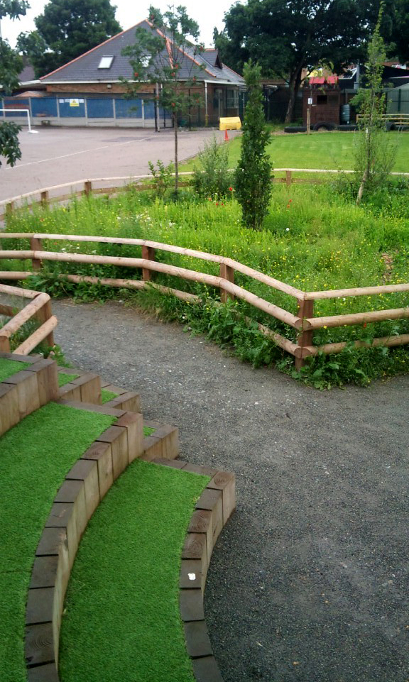 View of kitchen garden with school playgorund in background